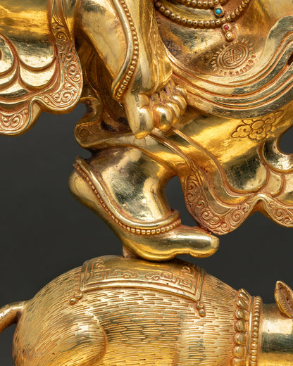 Ganesh statue hand detail holding sword near sacred mouse vehicle