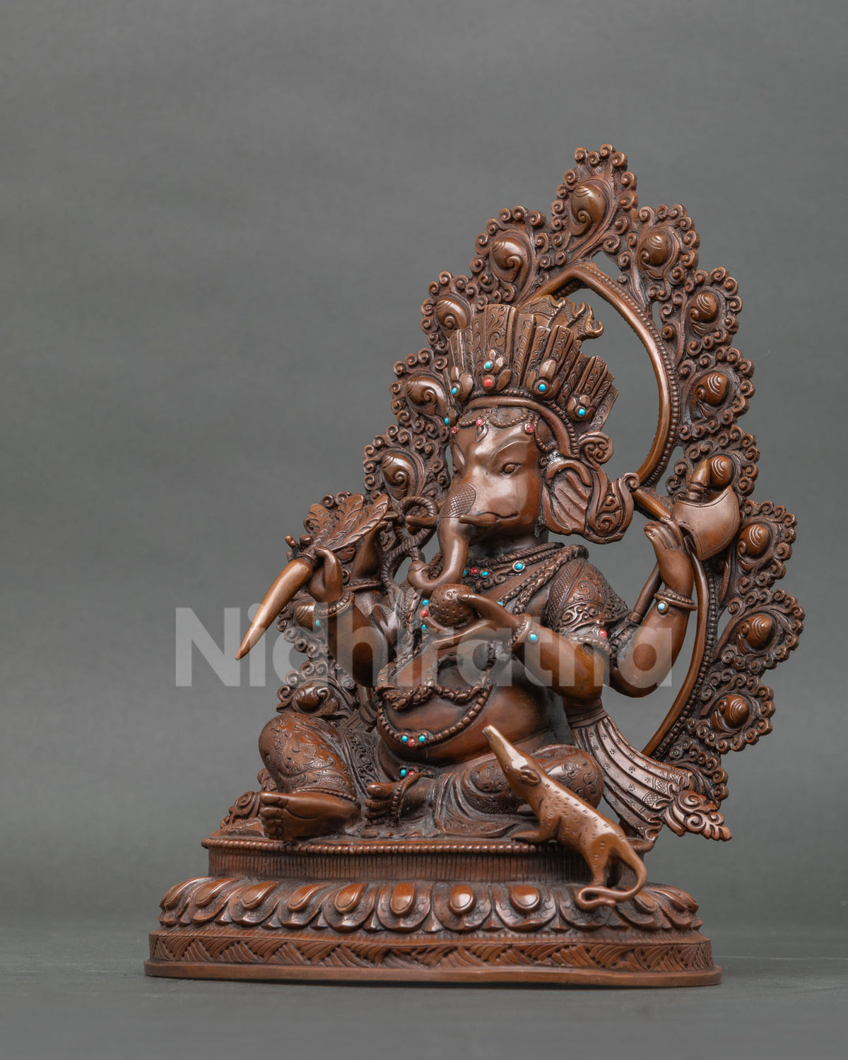 Ganesh Statue left side view with crown flowing robes and halo.