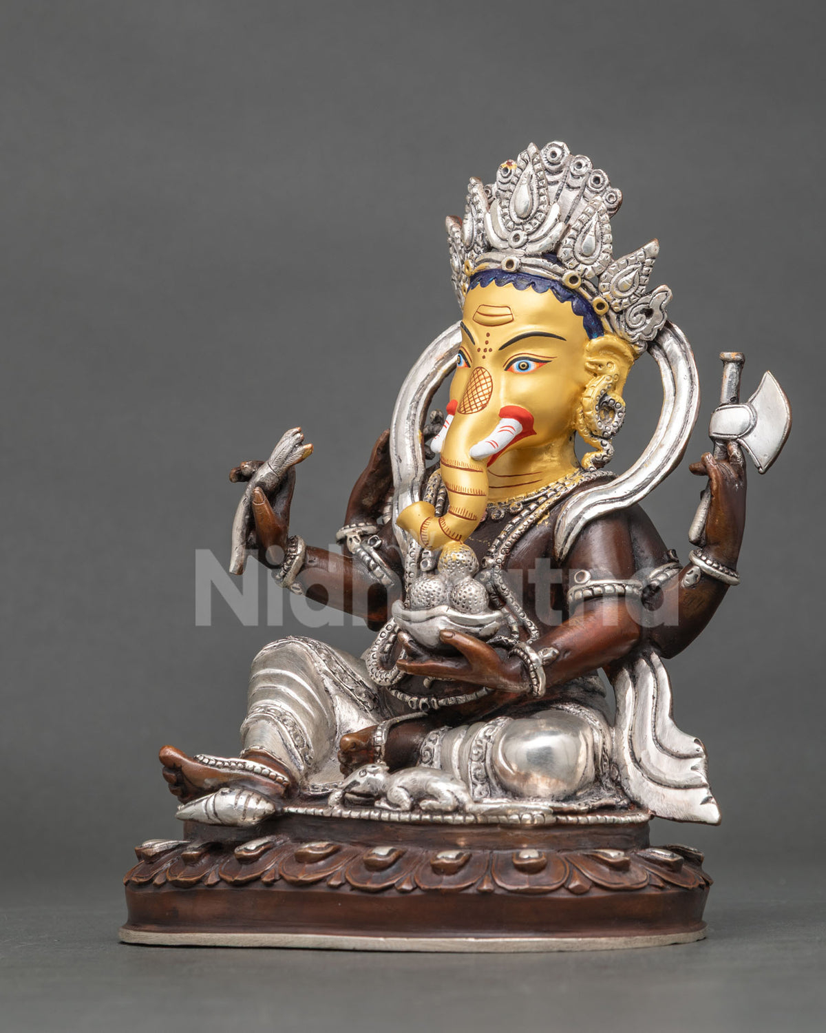 Ganesh statue left view majestic crown flowing robes 24K gold painted face Newari metal art.