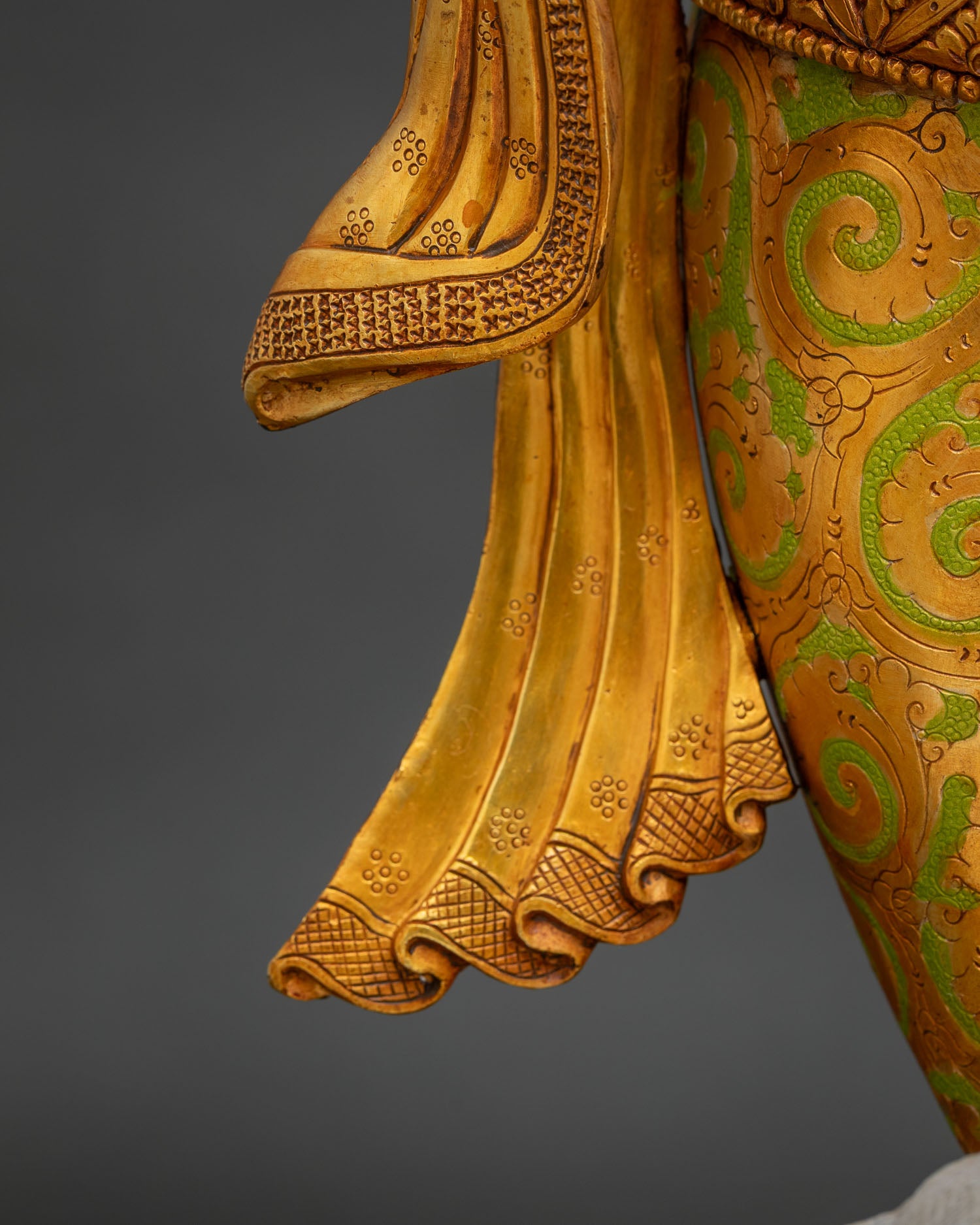 Ganesha statue golden sash drape detail showing hand-painted floral design