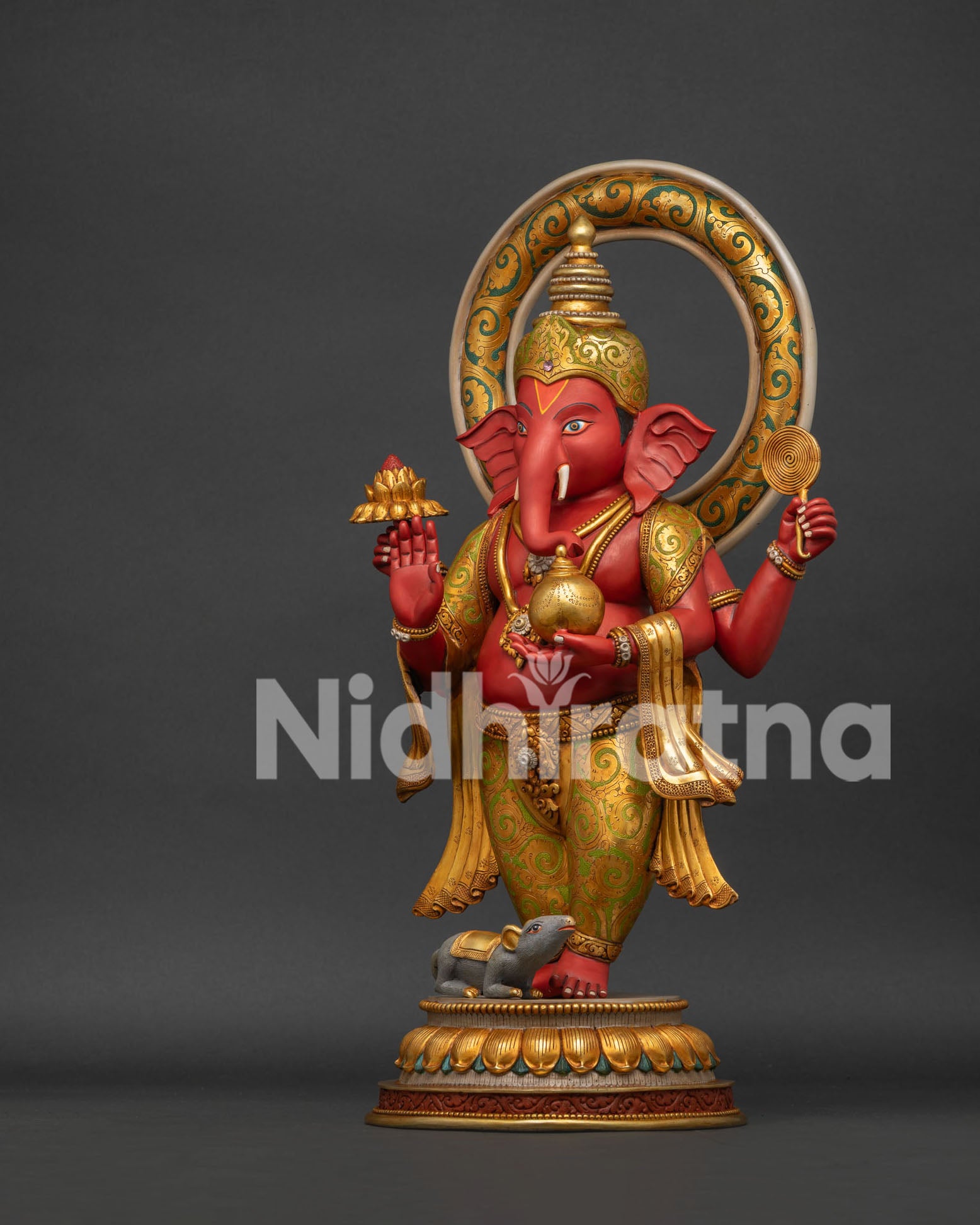 Ganesha statue upper body close-up showing gold jewelry and blessing hand gesture