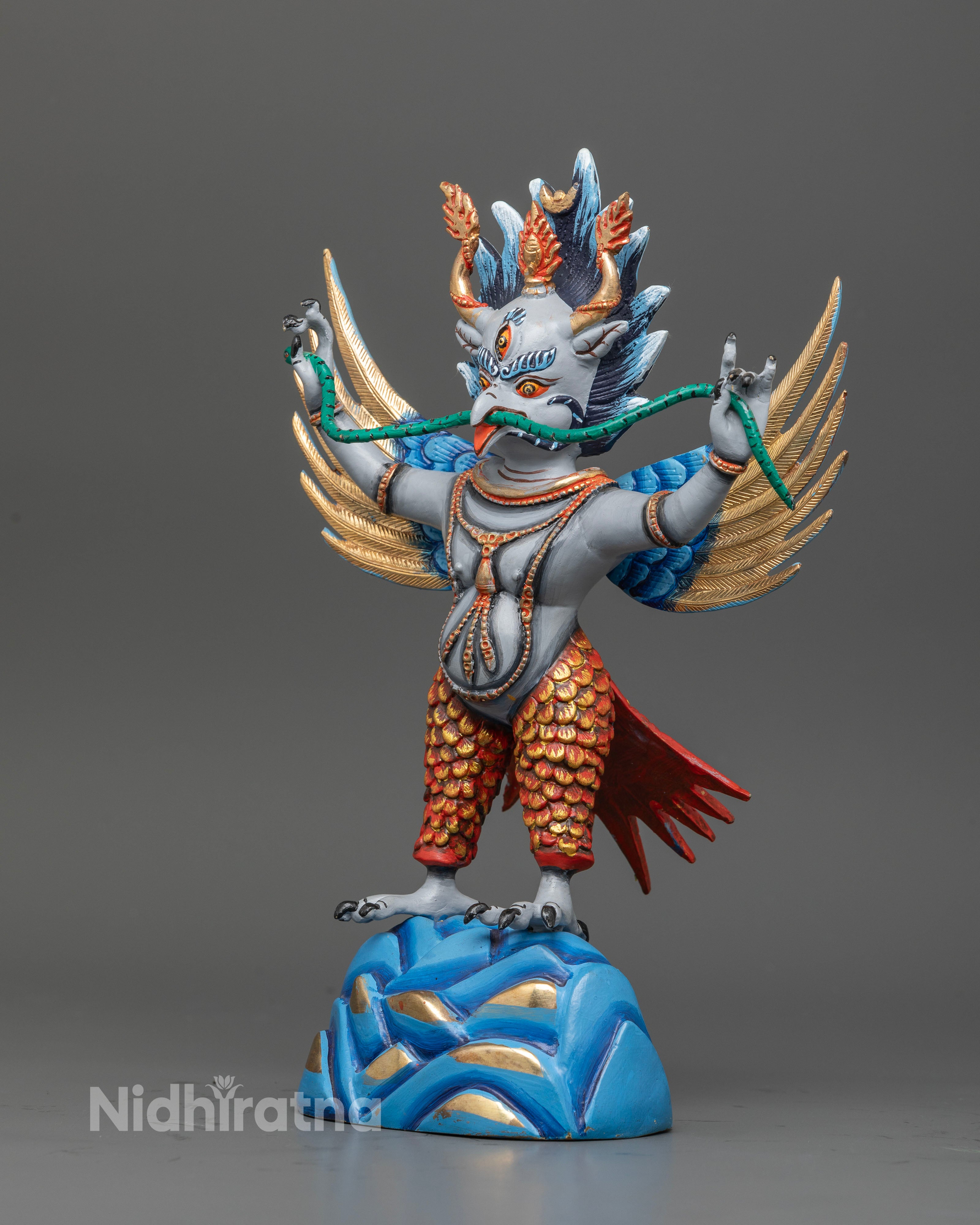 Garuda buddhist statue with widespread wings and intricately carved feathers.