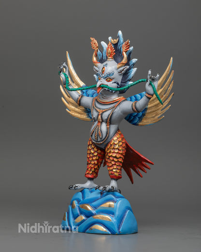 Garuda buddhist statue with widespread wings and intricately carved feathers.