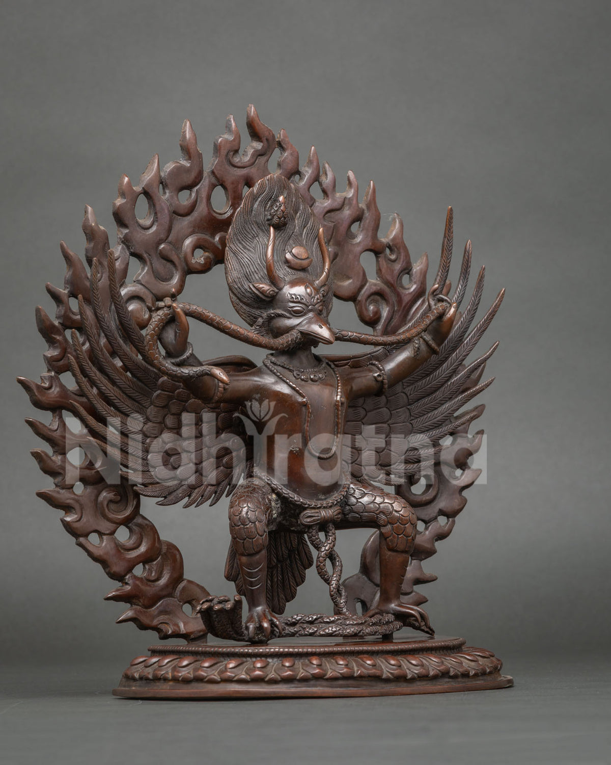 Garuda Buddhist statue with widespread wings intricately carved feathers and powerful talons.