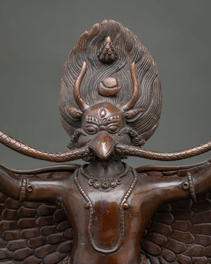 Garuda statue featuring a commanding expression intricate halo and finely carved feathers.