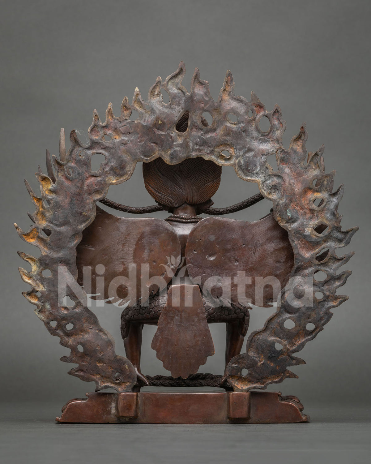 Garuda statue on a hand carved lotus throne showcasing oxidized copper and Newari craftsmanship from Patan Nepal.