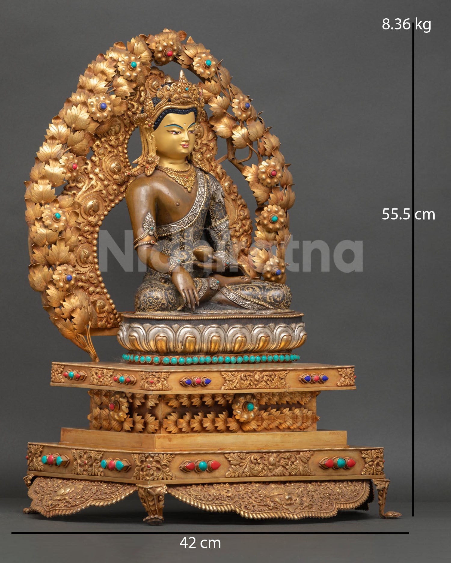 Gautama Buddha sculpture with gold gilded details semi precious stones and floral halo