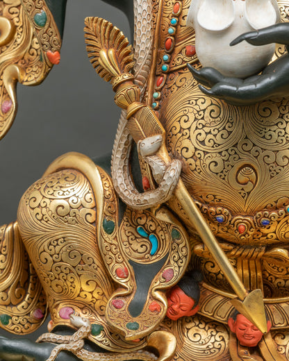 Gilded ritual staff with white serpent and red heads at Mahakala Bernagchen’s waist, gold scrollwork