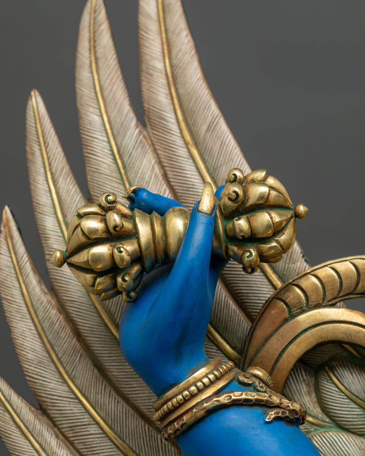 Gilded vajra held in Vajrakilaya’s hand with snake bracelet and finely engraved garuda feathers