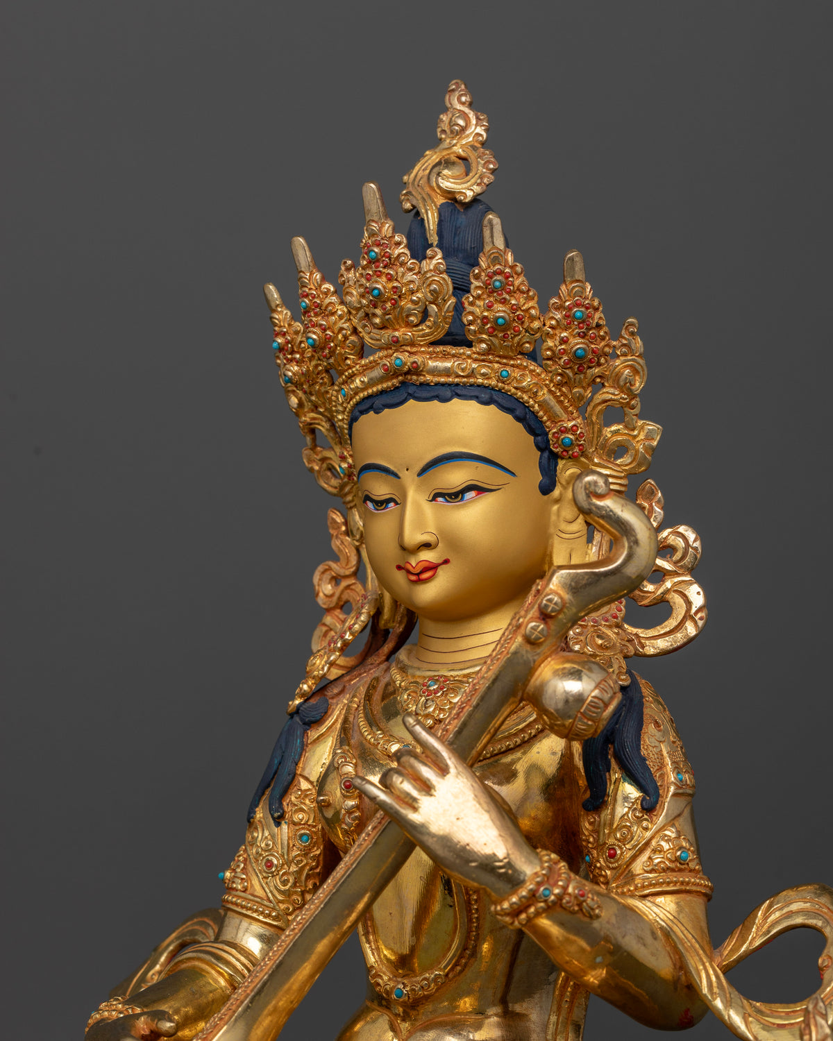 Goddess Saraswati Statue holding rosary mala sacred book and veena.