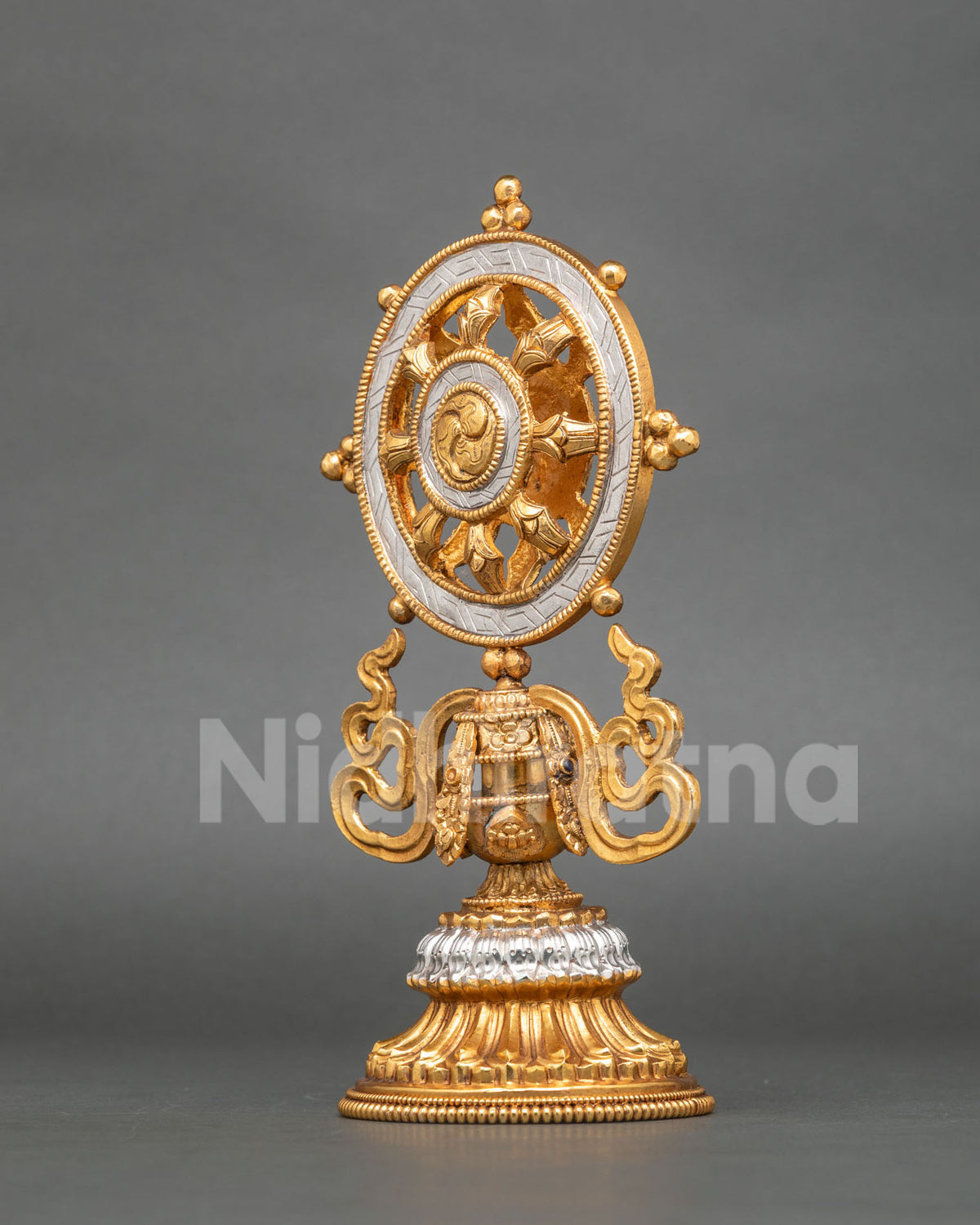 Gold and silver-plated Dharma Chakra featuring a detailed central hub and sacred Buddhist symbolism