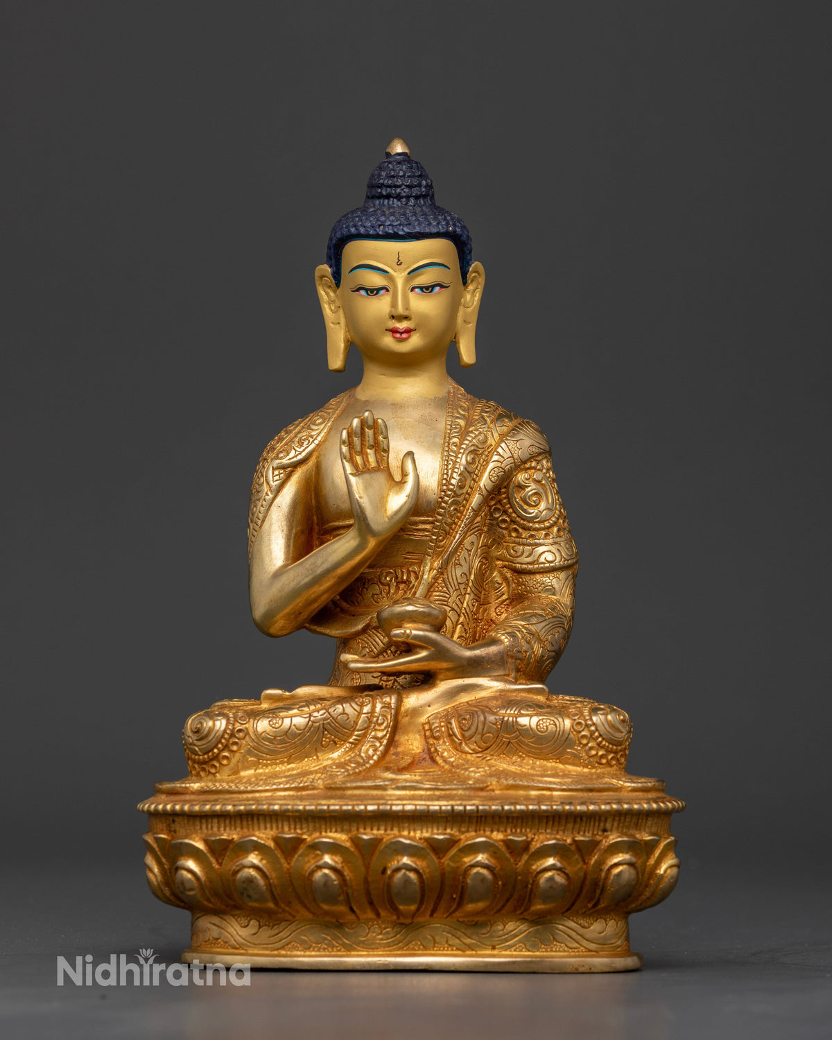 Gold fire gilded Amoghasiddhi Buddha Statue with Abhaya Mudra and sacred bowl.