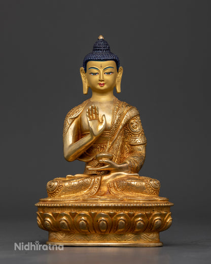 Gold fire gilded Amoghasiddhi Buddha Statue with Abhaya Mudra and sacred bowl.