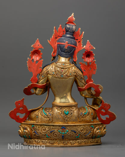 Gold fire gilded Green Tara statue with Varada Mudra on lotus pedestal.