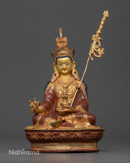 Gold fire gilded Guru Rinpoche Statue seated in royal ease on lotus throne.