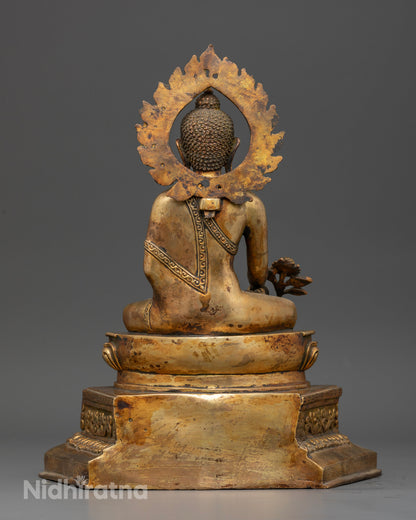 Gold fire gilded medicine buddha statue with antique finish and halo.