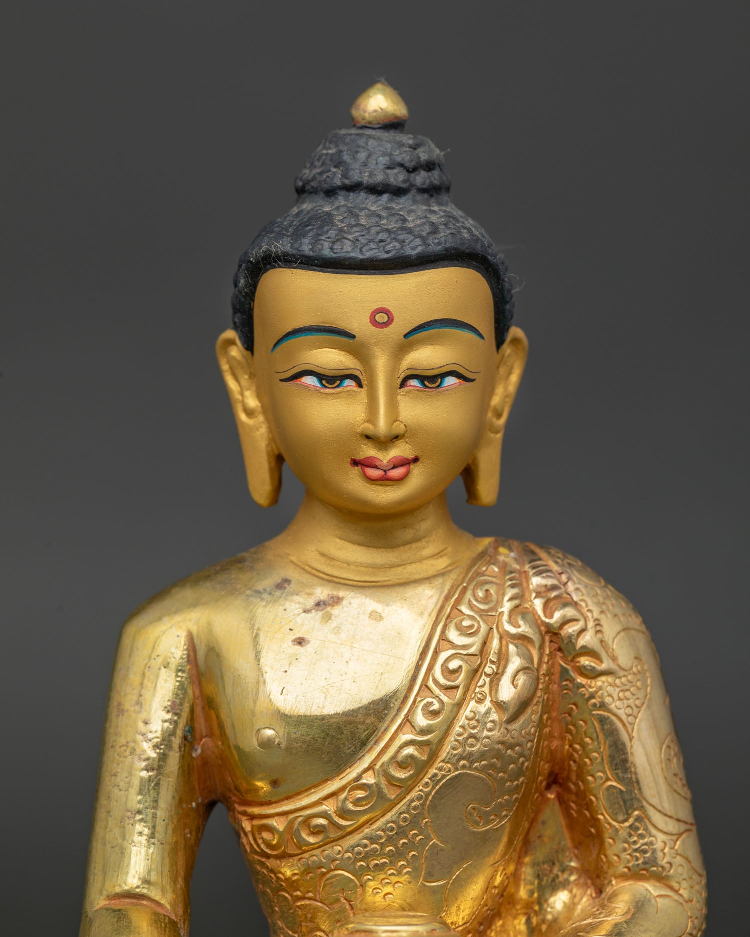 Gold fire-gilded Shakyamuni Buddha sculpture with serene gold-painted face.