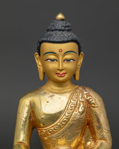 Gold fire-gilded Shakyamuni Buddha sculpture with serene gold-painted face.