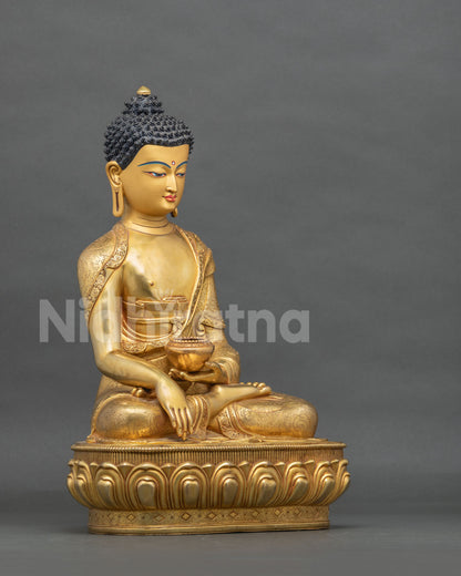 Gold fire-gilded Shakyamuni Buddha statue side view in earth-touching mudra holding patra bowl
