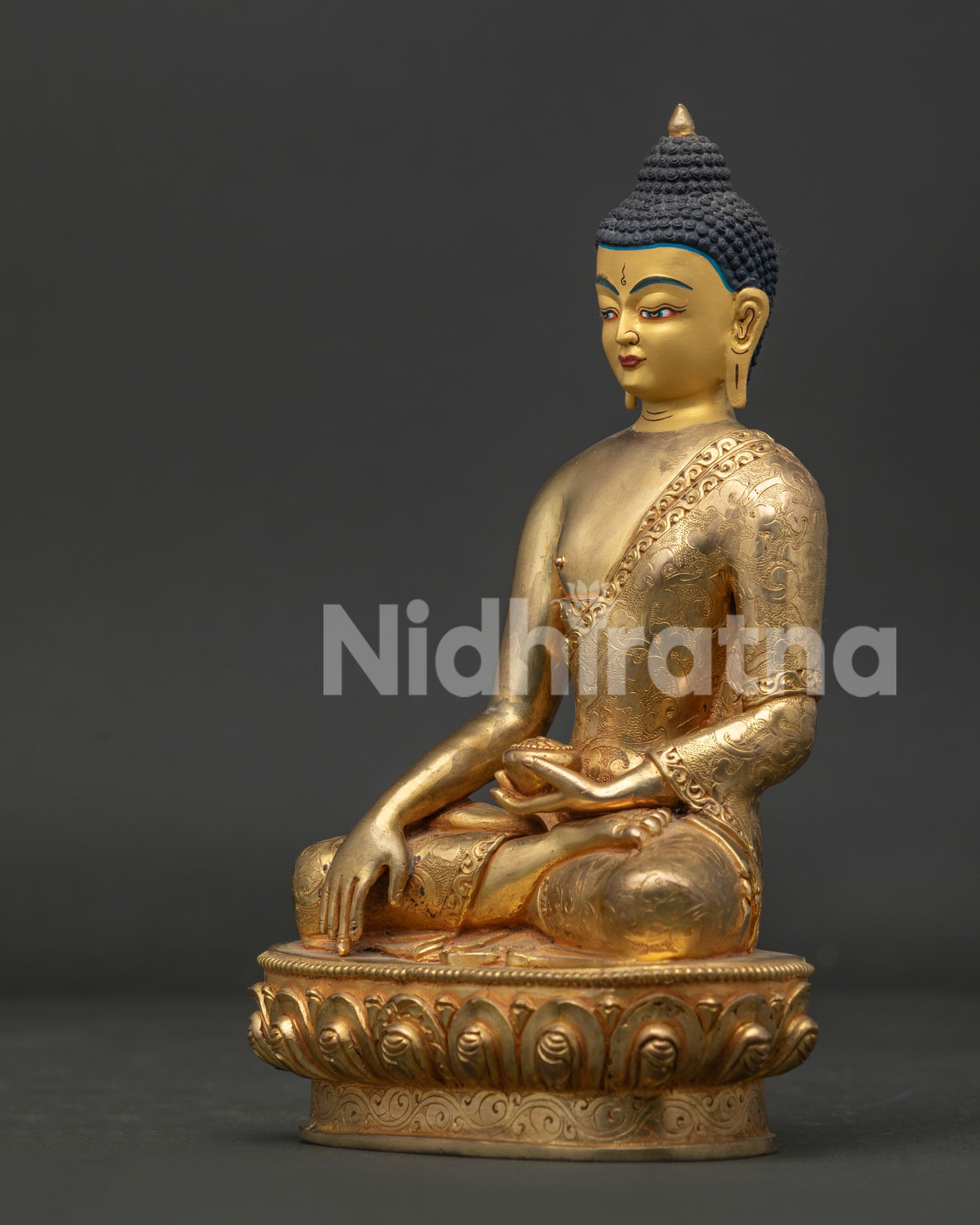 Gold fire gilded shakyamuni buddha statue with hand carved floral robe.