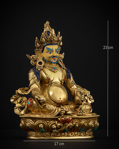 Gold gilded Dzambhala Buddhist wealth deity seated on lotus pedestal with conch shell