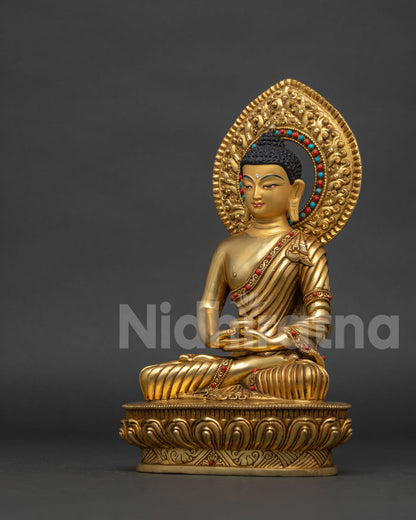 Gold gilded Amitabha Buddha statue with handcarved patterned motifs by Newari artisans.