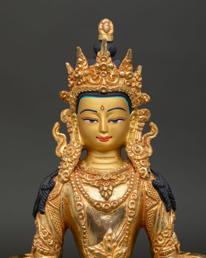 Gold gilded Amitayus Buddha showing painted face and traditional Nepalese craftsmanship.