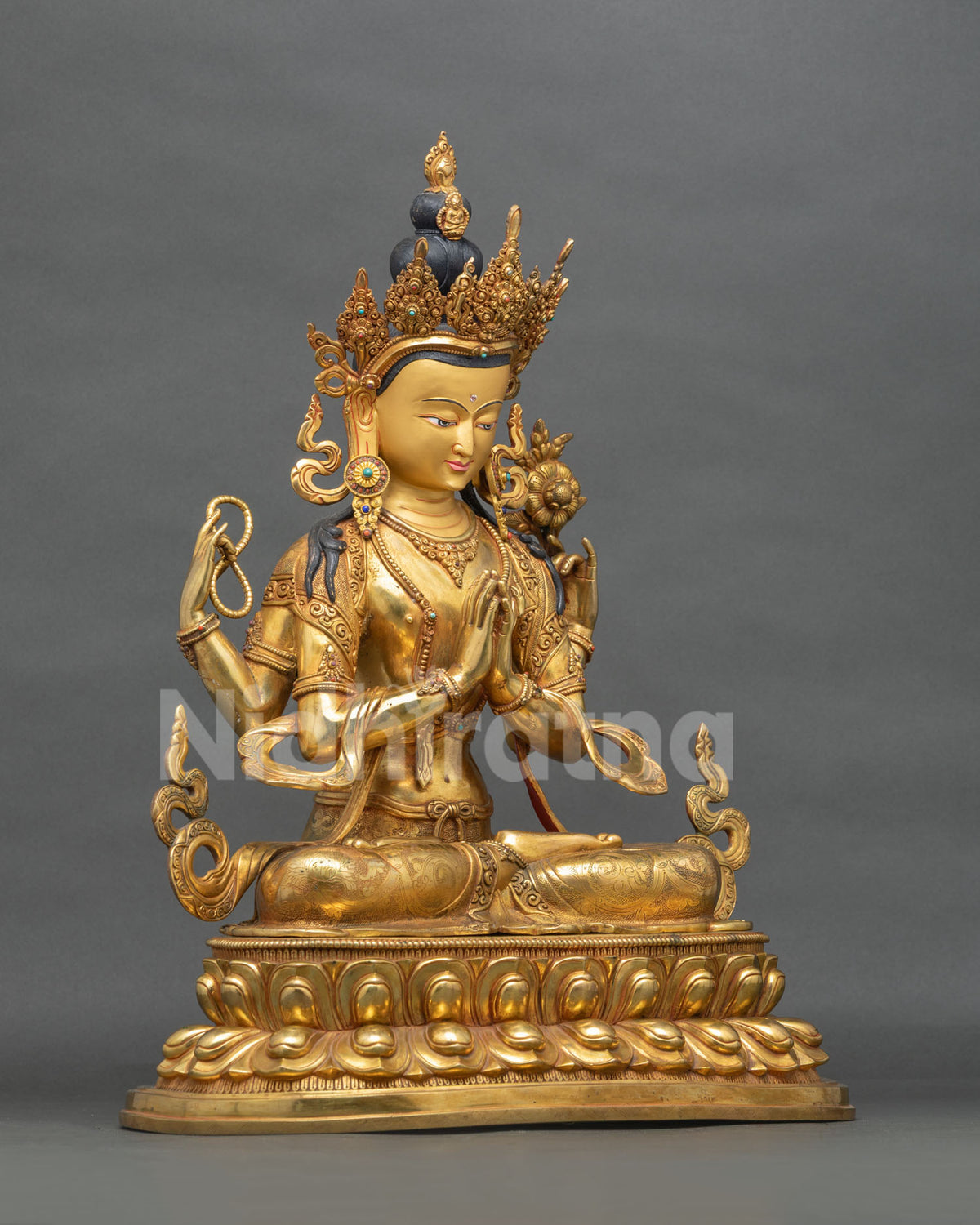 Gold gilded Chenrezig Avalokiteshvara statue side view with jeweled crown and lotus base