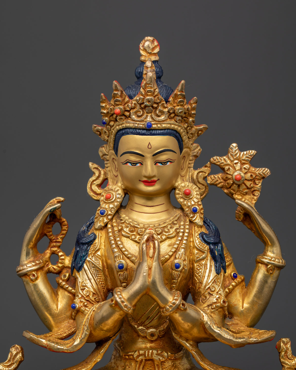 Gold-gilded Chenrezig Bodhisattva statue with a finely detailed gold-painted face and intricate ornamental carvings
