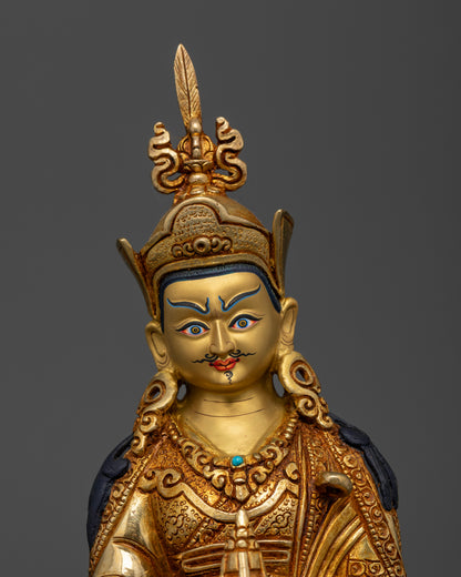 Gold-gilded copper Guru Rinpoche statue with intricate floral carvings and a gold-painted face