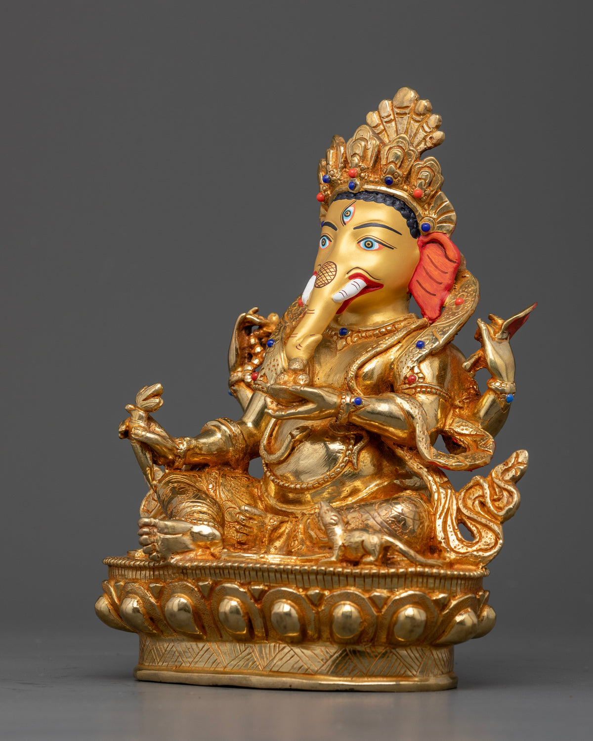 Gold-gilded Ganesh statue with mala, axe, broken tusk, Abhaya Mudra, and Mooshak mouse at his feet