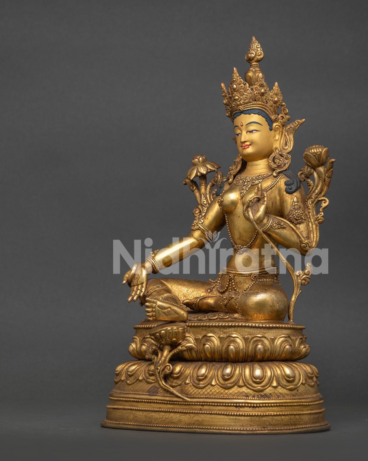 Gold gilded green tara statue with handcarved silk garment and flowing robe.