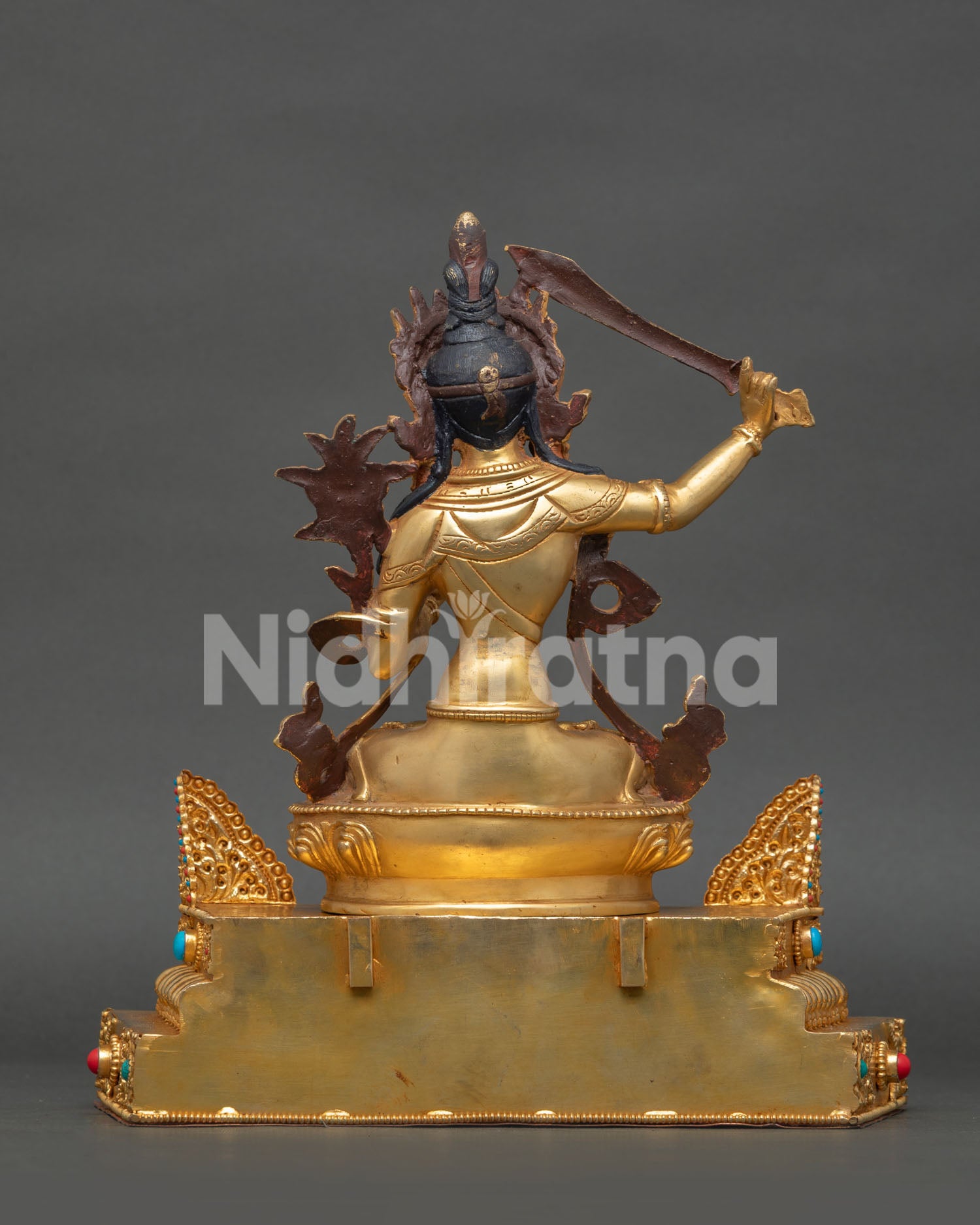 Gold gilded Manjushree statue with sacred Buddhist wisdom symbolism
