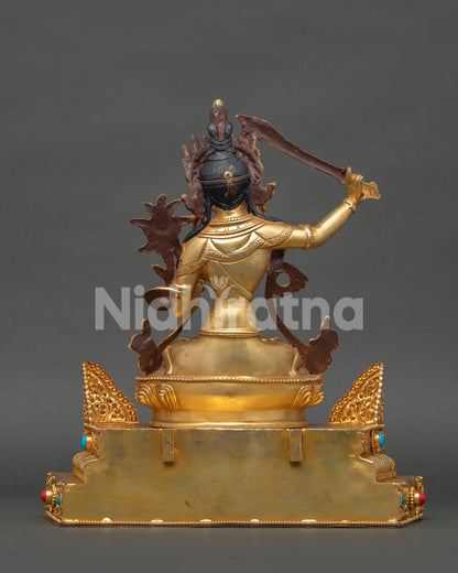 Gold gilded Manjushree statue with sacred Buddhist wisdom symbolism