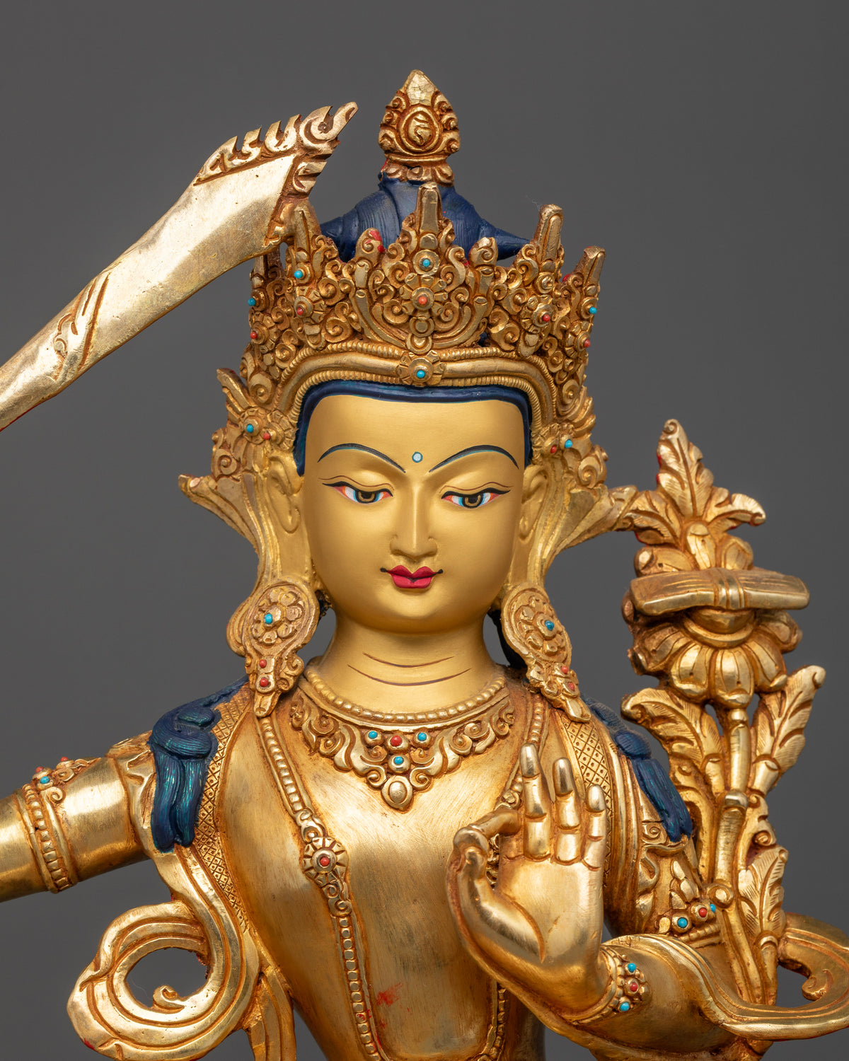 Gold gilded Manjushri Buddhist statue with gold painted face and intricate Newari craftsmanship