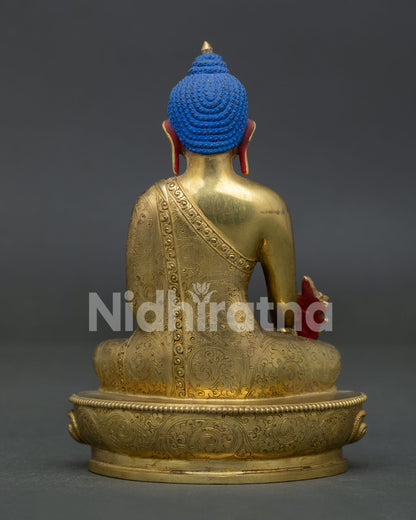 Gold gilded medicine buddha sculpture with carved monk robe nepalese buddhist art.