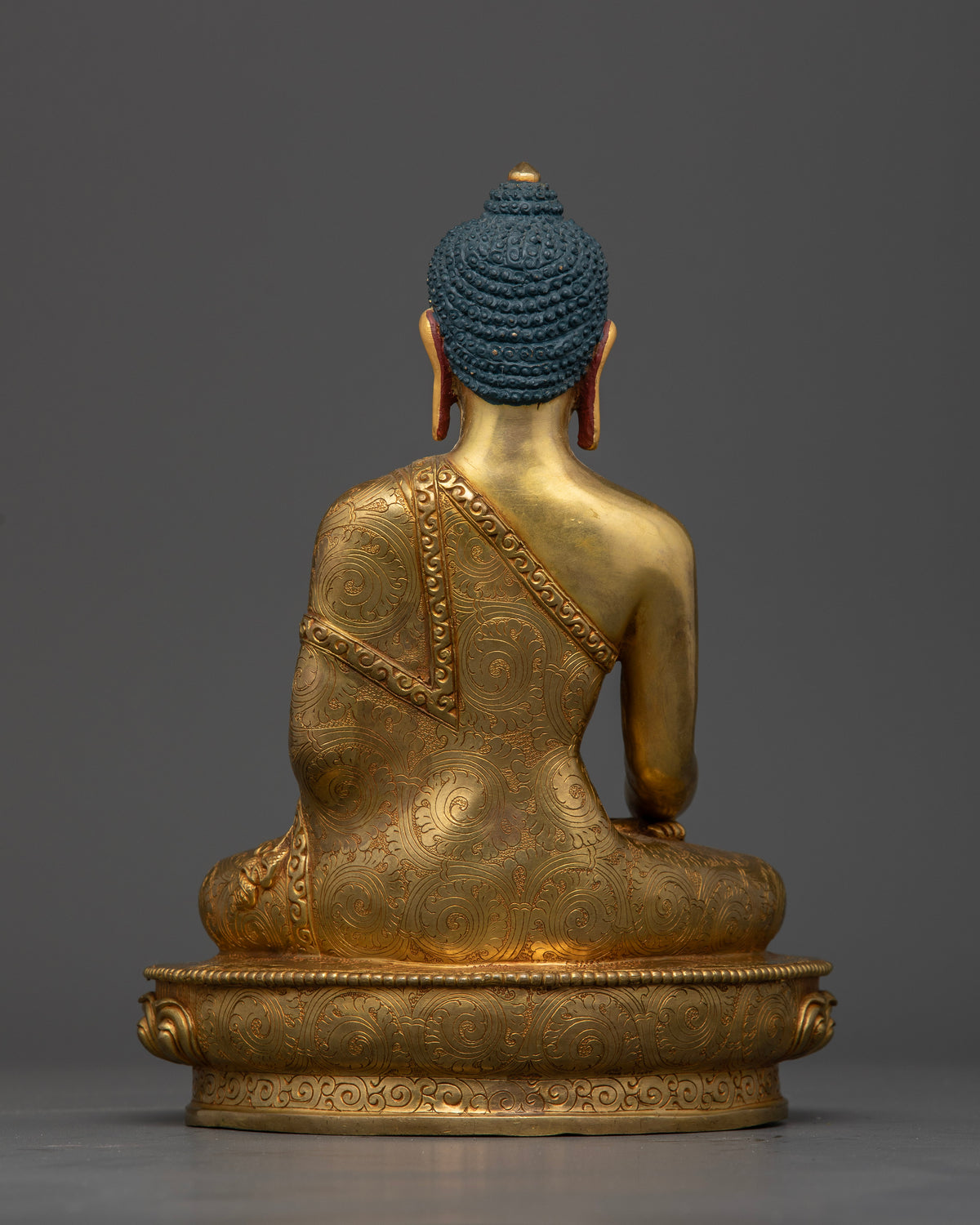 Gold-gilded Shakyamuni Buddha sculpture featuring hand-carved lotus pedestal and intricate monk robe motifs