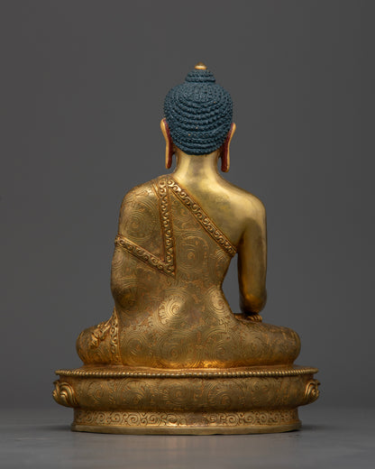 Gold-gilded Shakyamuni Buddha sculpture featuring hand-carved lotus pedestal and intricate monk robe motifs