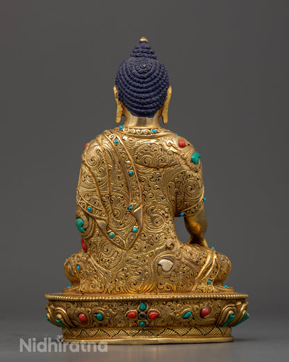 Gold-gilded Shakyamuni Buddha sculpture featuring intricate 3D hand-carved robes and floral motifs