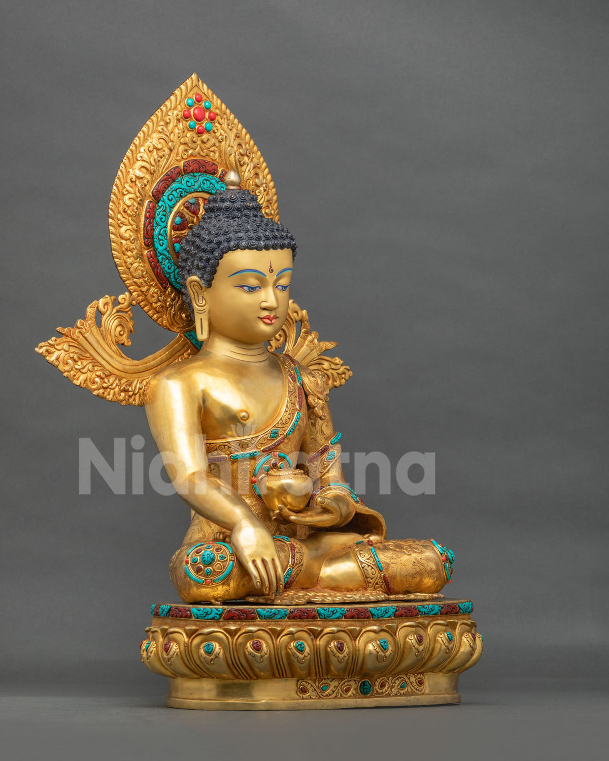 Gold gilded Shakyamuni Buddha statue side view with ornate halo and double lotus pedestal