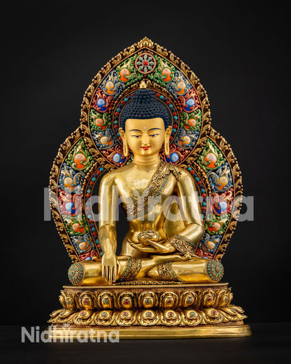 Gold-gilded Shakyamuni Buddha statue with ornate acrylic halo and lotus pedestal, handcrafted in Nepal