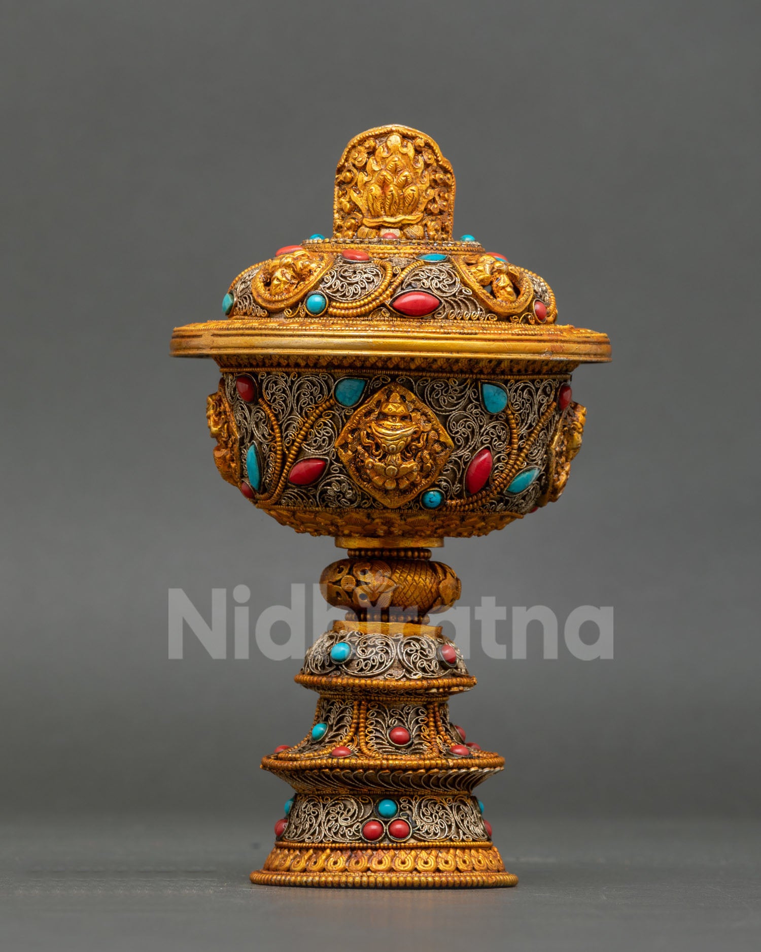 Gold-gilded Tibetan butter lamp body featuring Kirtimukha face medallion surrounded by silver filigree arabesques