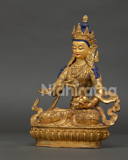 Gold gilded vajrasattva buddhist sculpture with carved monk robe and himalayan artistry.