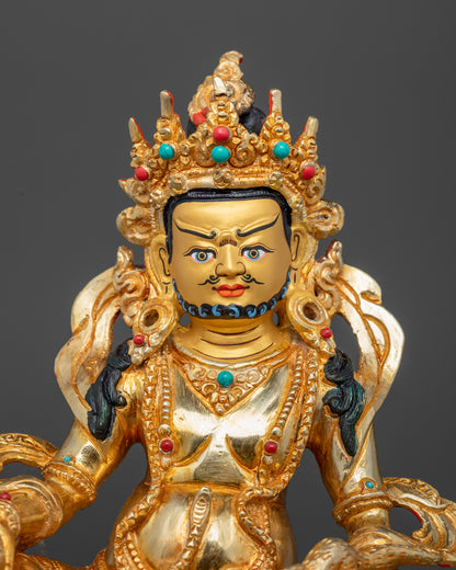 Gold-painted face of Nepalese Dzambhala Statue adorned with hand-set semi-precious stones