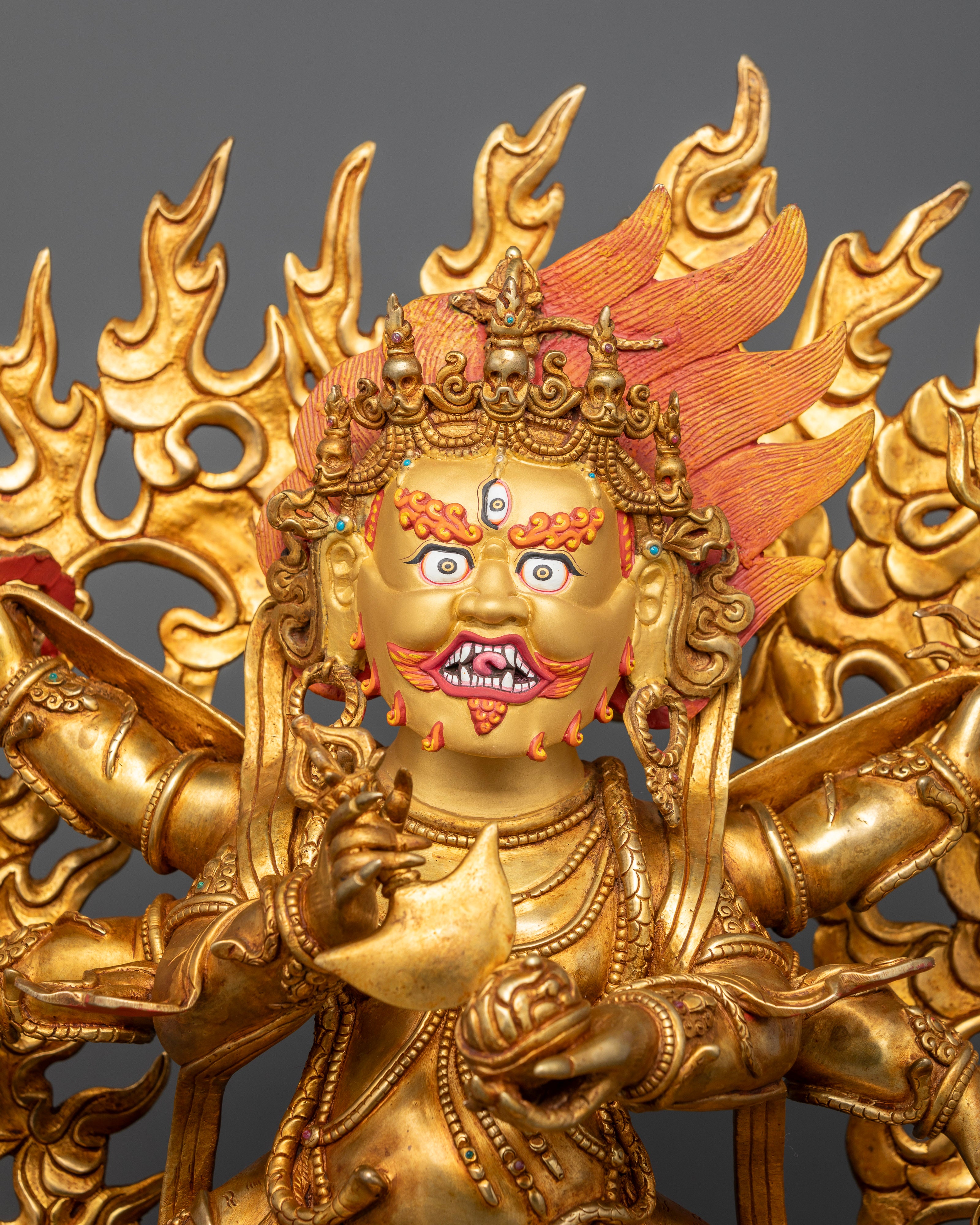Gold-painted face of Shadbhuja Mahakala Statue with third eye and blazing wisdom flames