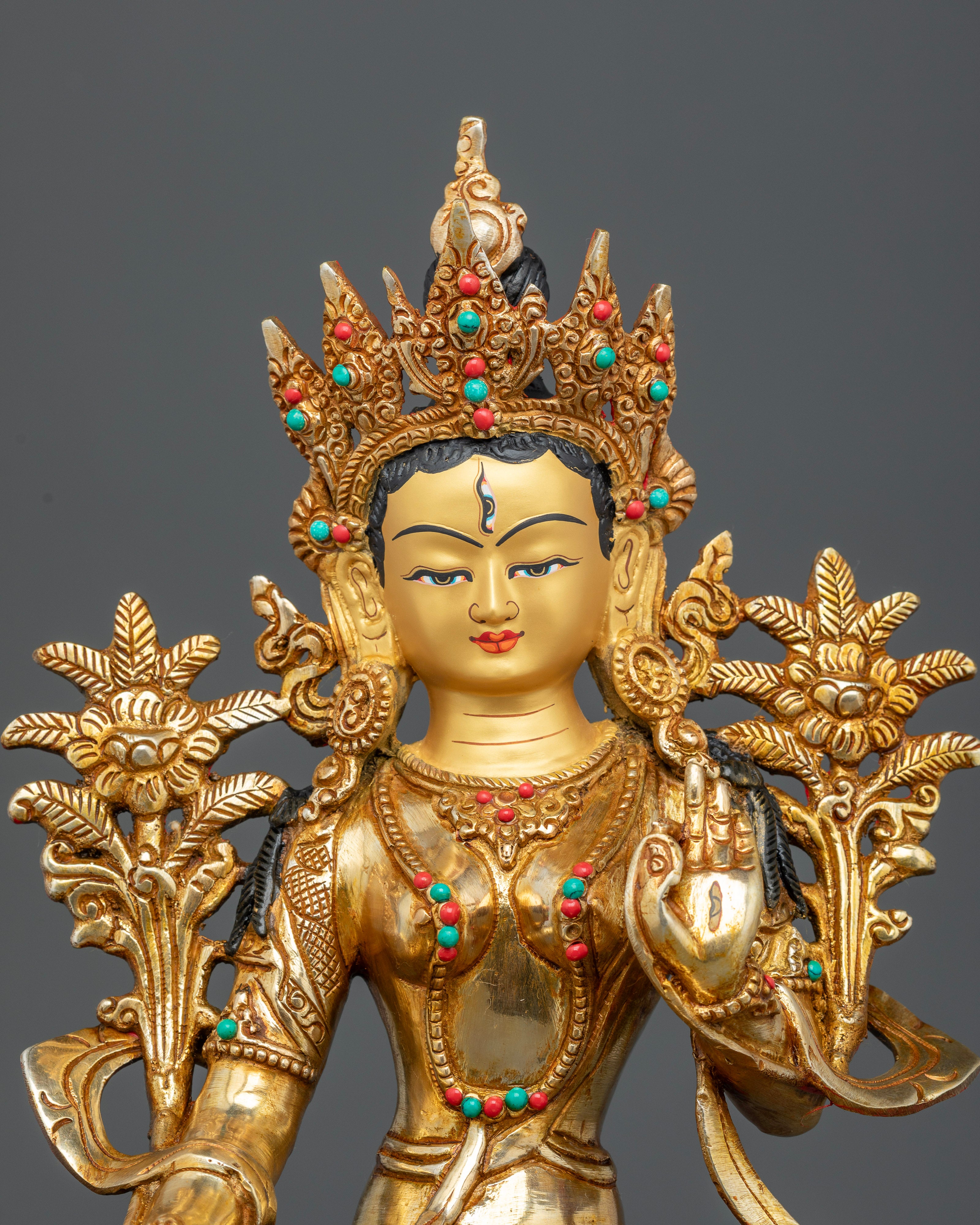 Gold painted face of White Tara Statue with semi precious stone inlays