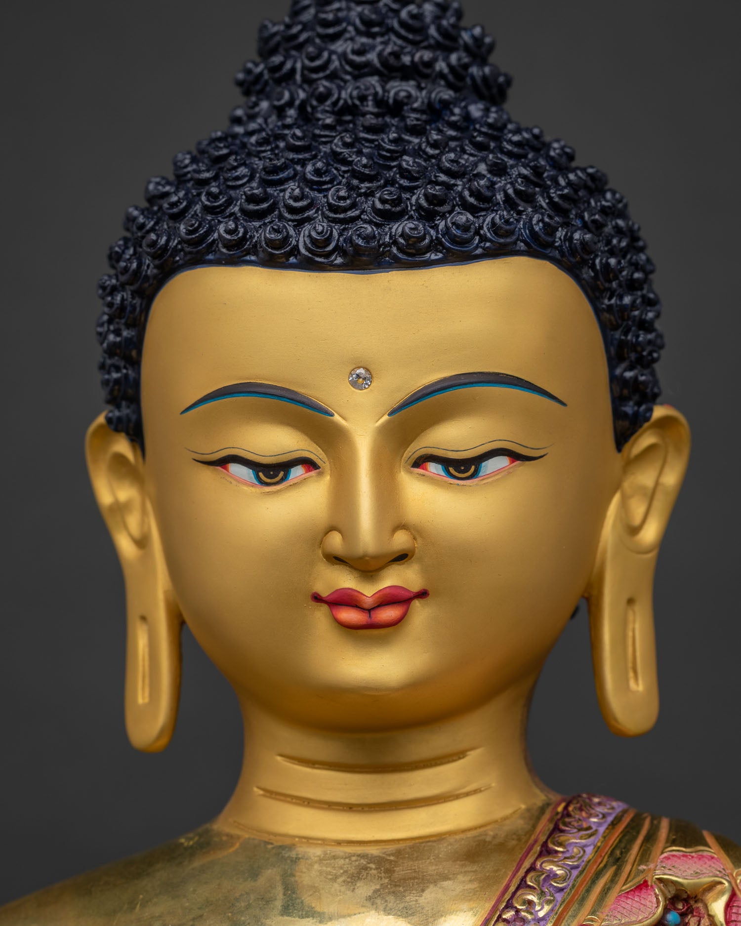 Gold-painted serene face of handcrafted Shakyamuni Buddha statue from Nepal