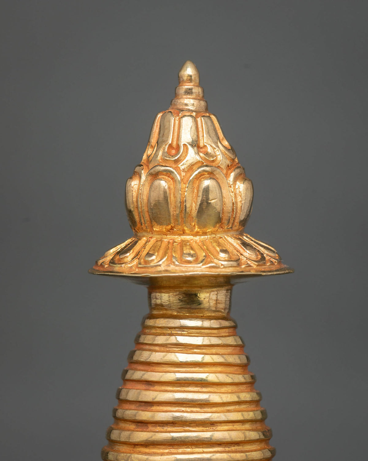 Gold-plated Kadampa Stupa featuring intricate floral carvings and traditional Nepalese metalwork