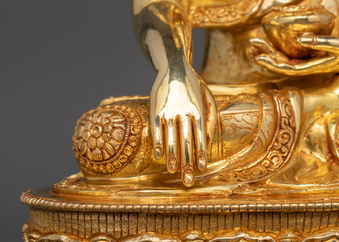 gold plated Shakyamuni Buddha hand touching the earth representing achievement of enlightment