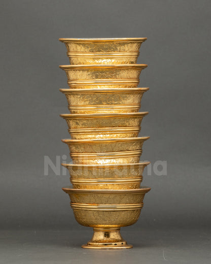 gold and silver-plated water offering set arranged on Tibetan Buddhist altar